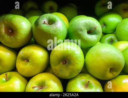 Green juicy organic Granny Smith Apples. Raw fruit background. Front view. Close up. Stock Photo