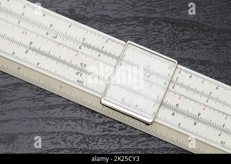 close up of old slide rule on black background Stock Photo