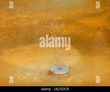 Mineral water bubbles into the tank in the spa Stock Photo