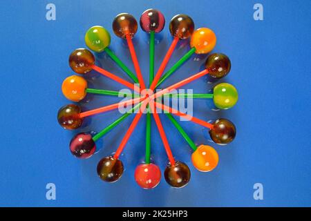 Mix of colorful lollipops. Children lollipops on a pastel background. Copy space, flat lay. Lollipops on a dark blue background Stock Photo