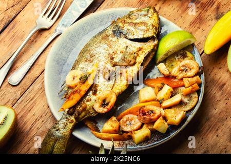 Baked gilthead fish in fruit. Stock Photo