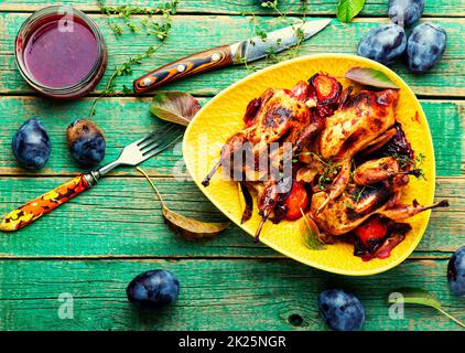 Quail stuffed with plums. Stock Photo