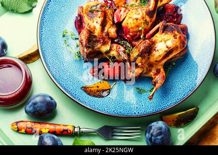 Quail stuffed with plums. Stock Photo