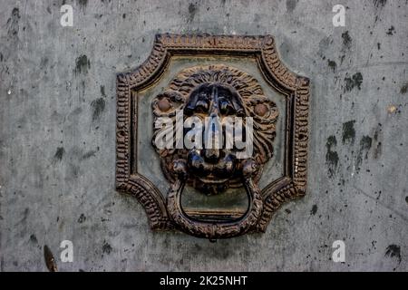 Retro door knocker mounted on a wooden door Stock Photo
