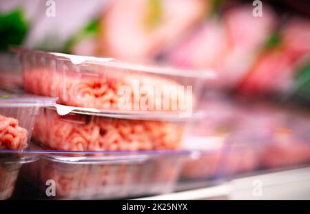 Meat products put up for sale in a supermarket commercial fridge Stock Photo