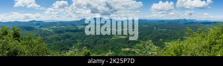 Panoramic shot of forests and hills on a cloudy day Stock Photo