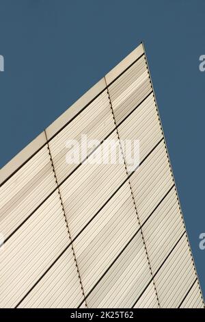 Lines and rectangles texture formed on white metal wall of building with blue sky in background. Abstract modern architecture background. Stock Photo