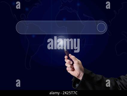 a man's hand holds a magnifying glass on the background of a template for entering and searching information on the Internet. Globalization, availability of information Stock Photo