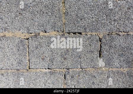 old wall with rough structure made of huge grey bricks Stock Photo