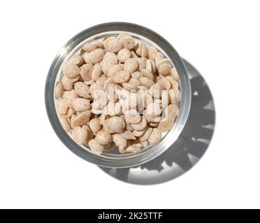 Cosmetic Chemical in glass container. Sumac Wax is a natural, vegetable wax, pale in colour, extracted from the berry kernels of several varieties of the Rhus Verniciflua tree. Stock Photo