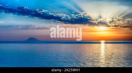 Scenic sunset with view over Stromboli Volcano from Tropea, Italy Stock Photo