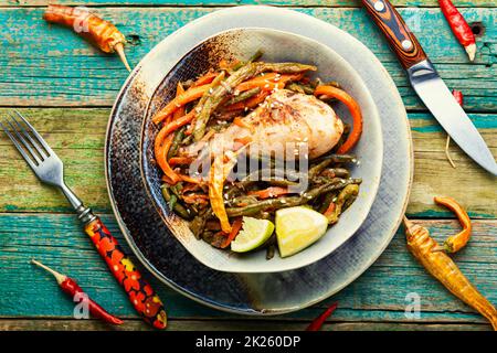 Fried spicy chicken legs and vegetables Stock Photo