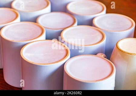 White coffee cups on wooden table tropical Holbox island Mexico. Stock Photo