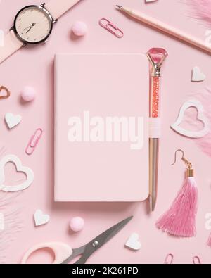 Hardcover notebook, Pink school girly accessories and hearts on pastel pink Top view, mockup Stock Photo