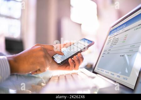 Online Banking On Mobile Phone And Hybrid Laptop Stock Photo