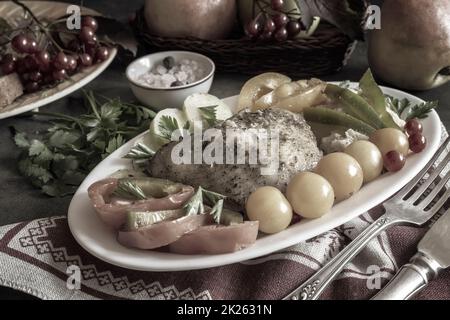 Baked chicken leg on a plate with vegetables Stock Photo
