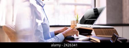 African American Coder Using Computer At Desk Stock Photo