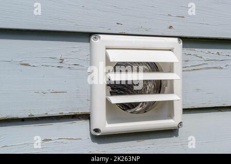 Plastic dryer exhaust vent with open flaps while dryer is on Stock Photo