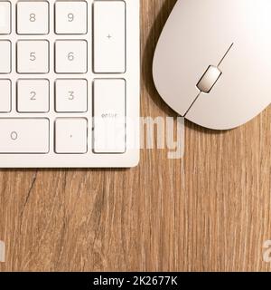 Keyboard from a computer and a computer mouse on a desk in the office Stock Photo