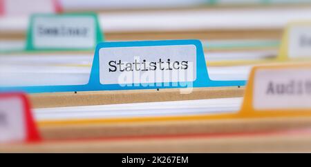 File folders with a tab labeled Statistics Stock Photo