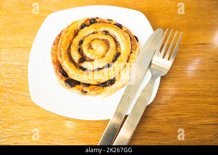 Cinnamon rolls buns baking on a white plate breakfast table Top view. Stock Photo