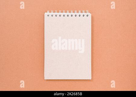 Blank spiral bound notepad on the cardboard background Stock Photo