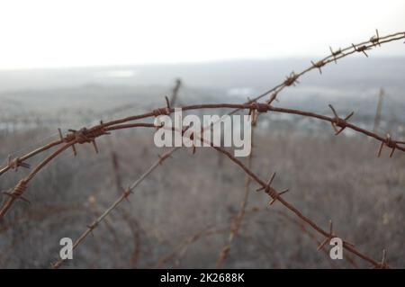 A barbed wire fence on Minefield in the Golan Heights, Israel Stock Photo