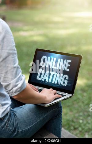 Text showing inspiration Online Dating. Business idea Searching Matching Relationships eDating Video Chatting Woman Typing On Laptop Sitting Outside Side View Working From Home. Stock Photo