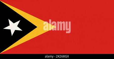 Flag of East Timor. East Timorflag on fabric surface. Fabric Texture Stock Photo