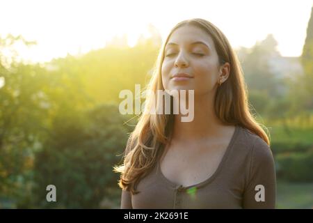 Portrait of beauty woman breathing fresh air against natural background. Copy space Stock Photo