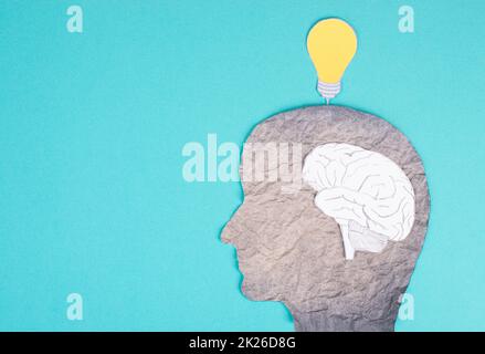 Silhouette of a man with a brain and a light bulb over the head, brainstorming new ideas, thinking out of the box, creativity concept Stock Photo