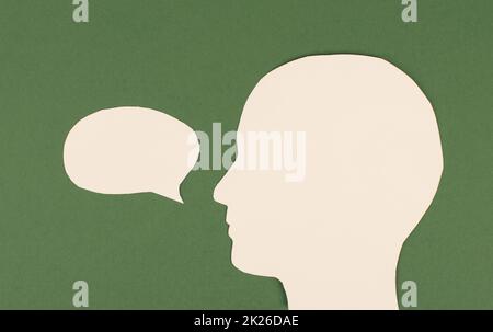 Silhouette of a face, speech bubble in white color, copy space for text, communication, having an opinion, free speech Stock Photo