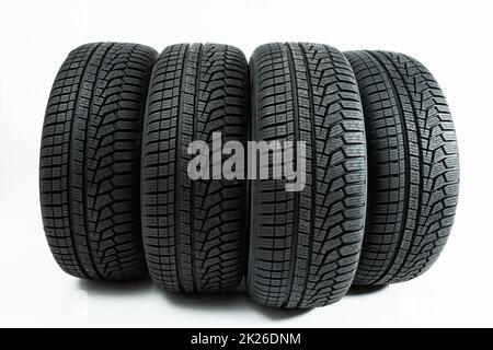 Winter tires rolling forward isolated on white background. Stock Photo