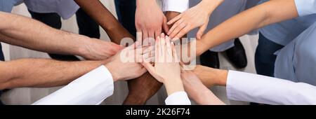 Elevated View Of Doctors Stacking Hands Stock Photo