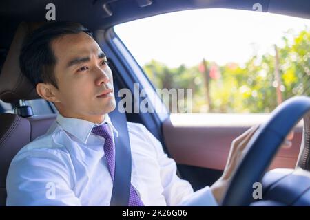 Handsome young man driving a car Stock Photo