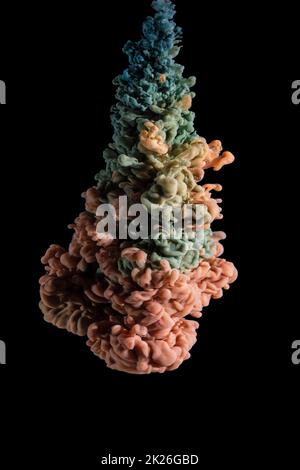 cloud of various acrylic colors expanding in water Stock Photo