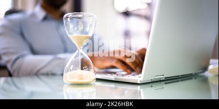 Financial Deadline And Hourglass In Office Stock Photo