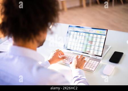 Data Analyst African Man Using Spreadsheet Stock Photo