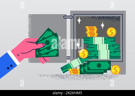 Businessman put banknotes in vault Stock Photo