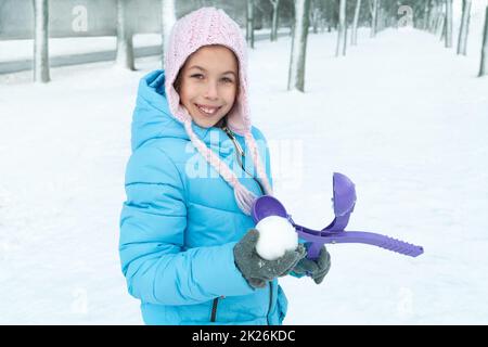 Portrait of a girl in winter in a hat and jacket Stock Photo