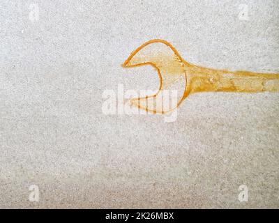 Yellow ring wrench print on a brown background Stock Photo