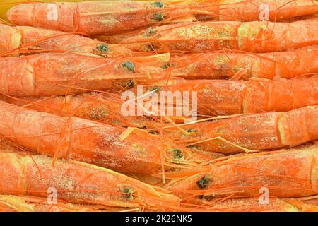 Frozen extra large tiger prawns served on ice. Top view. Close-up Stock Photo