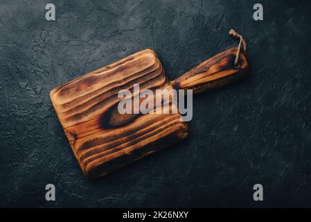 Cutting Board with Handle on Concrete Surface Stock Photo