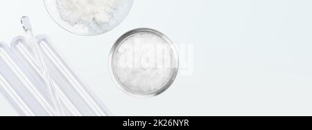 Microcrystalline wax in glass container and Cetyl esters wax in chemical watch glass placed next to the stirring rod and test tube. Stock Photo