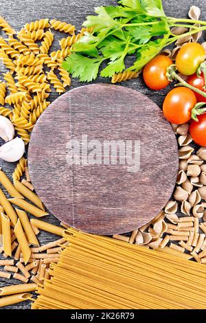 Frame different whole grain and rye pasta on board Stock Photo