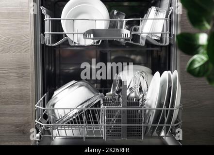 https://l450v.alamy.com/450v/2k26rfr/open-dishwasher-with-clean-utensil-inside-cutlery-glasses-dishes-at-kitchen-2k26rfr.jpg