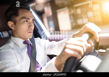 Handsome young man driving a car Stock Photo