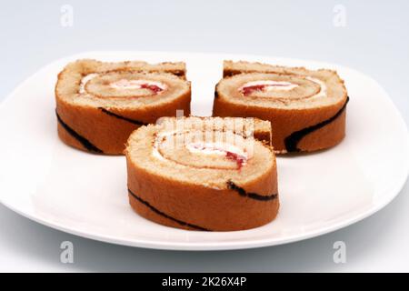 Sliced roll on a plate. Stock Photo