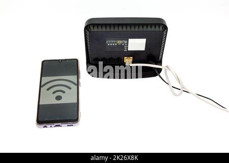 Black wifi router and mobile phone with wifi sign on the screen ...