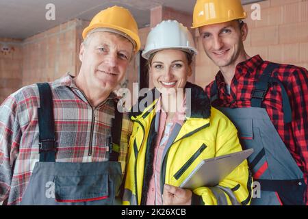 Portrait of female engineer with two male workers Stock Photo